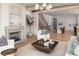 Inviting living room with fireplace, hardwood floors, and open layout to dining room at 1214 S Kings Dr # A, Charlotte, NC 28207