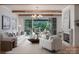 Bright living room featuring a cozy fireplace, plush sofa, and access to an outdoor balcony with scenic views at 1214 S Kings Dr # A, Charlotte, NC 28207