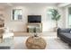 Modern living room with hardwood floors, a tv, large windows, and lots of seating space at 1214 S Kings Dr # A, Charlotte, NC 28207