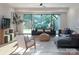 Bright living room featuring a cozy seating area, natural light, and backyard views at 1214 S Kings Dr # A, Charlotte, NC 28207