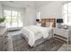 Comfortable main bedroom with a large window, neutral tones, and an area rug at 1214 S Kings Dr # A, Charlotte, NC 28207