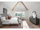 Bright main bedroom features large windows, hardwood floors, vaulted ceiling, and modern decor at 1214 S Kings Dr # A, Charlotte, NC 28207