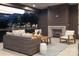 Covered outdoor living area with a stone fireplace and comfortable seating, perfect for entertaining at 1214 S Kings Dr # A, Charlotte, NC 28207
