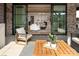 Relaxing outdoor patio with comfortable seating, wooden table and large sliding glass doors at 1214 S Kings Dr # A, Charlotte, NC 28207