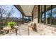 Covered porch with wicker furniture and view of backyard at 1214 S Kings Dr # A, Charlotte, NC 28207