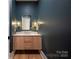 Elegant powder room with floating vanity and dark walls at 1214 S Kings Dr # A, Charlotte, NC 28207