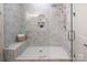 Beautifully tiled shower with a built-in seat and marble accents at 1214 S Kings Dr # A, Charlotte, NC 28207