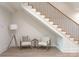 Bright stairway with wood steps, black metal railings, and a cozy sitting area underneath at 1214 S Kings Dr # A, Charlotte, NC 28207