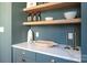 Stylish wet bar with open shelving, marble counters, and designer accessories at 1214 S Kings Dr # A, Charlotte, NC 28207