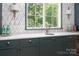 Chic wet bar features marble countertops, custom cabinetry, and stylish fixtures at 1214 S Kings Dr # A, Charlotte, NC 28207