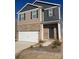 Two-story brick home with gray siding and a brown door at 141 Hayes Rd, Kings Mountain, NC 28086