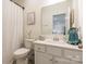 Bright bathroom with white vanity, decorative mirror, and shower with white curtain at 14450 Maritime Dr, Lancaster, SC 29720