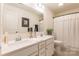 Neutral bathroom with double sink vanity, framed mirror, and a shower behind a curtain at 14450 Maritime Dr, Lancaster, SC 29720