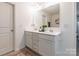 Bathroom with double sink vanity, large mirror, and modern fixtures, with decorative rug at 14450 Maritime Dr, Lancaster, SC 29720
