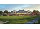 Image shows beautiful clubhouse, manicured lawn and golf course at 14450 Maritime Dr, Lancaster, SC 29720