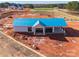 Construction progress, shows a partially-built structure with a new blue roof at 14450 Maritime Dr, Lancaster, SC 29720