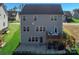 Exterior of home featuring a spacious deck, lower patio, and a beautifully landscaped backyard at 14450 Maritime Dr, Lancaster, SC 29720