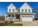 Charming two-story home with a welcoming front porch and an attached two-car garage at 14450 Maritime Dr, Lancaster, SC 29720