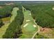 Scenic aerial view of the lush green golf course surrounded by dense trees at 14450 Maritime Dr, Lancaster, SC 29720