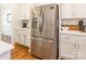 Kitchen boasts stainless steel refrigerator, white cabinets, and light countertops at 14450 Maritime Dr, Lancaster, SC 29720