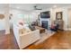 Open-concept living room with hardwood floors, a fireplace, and large windows at 14450 Maritime Dr, Lancaster, SC 29720