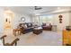 Inviting living room features a brown leather sofa and ottoman near bright windows at 14450 Maritime Dr, Lancaster, SC 29720
