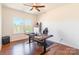 Home office with large window and modern desk setup with ceiling fan and hardwood floors at 14450 Maritime Dr, Lancaster, SC 29720