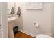 Powder room features a pedestal sink and minimalist decor with hardwood floors at 14450 Maritime Dr, Lancaster, SC 29720