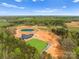 Expansive aerial view of the property featuring a house, pond, and extensive landscape at 1565 Shinnville Rd, Cleveland, NC 27013