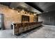 Chic bar area with brick wall, pendant lights, and sleek modern bar stools, perfect for entertaining at 1565 Shinnville Rd, Cleveland, NC 27013