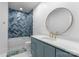 Modern bathroom showcasing blue tile and a gold-framed round mirror above the vanity at 1565 Shinnville Rd, Cleveland, NC 27013