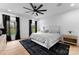 Bright bedroom with a black ceiling fan, ensuite windows, and hardwood floors at 1565 Shinnville Rd, Cleveland, NC 27013