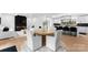 Open dining area that showcases a view into the modern kitchen and fireplace at 1565 Shinnville Rd, Cleveland, NC 27013