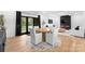 Open dining area with a fireplace, black-framed glass doors, and a hardwood floor at 1565 Shinnville Rd, Cleveland, NC 27013