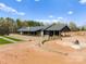Expansive estate featuring stone and black siding, covered patio and outdoor space, perfect for lavish country living at 1565 Shinnville Rd, Cleveland, NC 27013