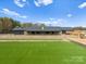 Spacious lawn and stone home offer privacy and luxury, enhanced by manicured grounds and natural surroundings at 1565 Shinnville Rd, Cleveland, NC 27013