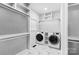 Spacious laundry room with modern washer and dryer, and built in storage shelves at 1565 Shinnville Rd, Cleveland, NC 27013