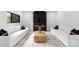 Bright living room with a modern fireplace, white sofas, and hardwood floors at 1565 Shinnville Rd, Cleveland, NC 27013