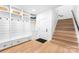 Welcoming mudroom with built-in storage and seating next to wood staircase at 1565 Shinnville Rd, Cleveland, NC 27013