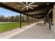 Spacious covered patio with views of a pristine artificial turf and a wide open field at 1565 Shinnville Rd, Cleveland, NC 27013