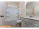 Well-lit bathroom showcasing a shower-tub combo, white vanity, and a window providing natural light at 1630 Troon Dr, Salisbury, NC 28144