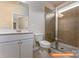 Well-lit bathroom featuring a vanity with a quartz countertop, a toilet, and glass-enclosed shower at 1630 Troon Dr, Salisbury, NC 28144