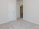 Bedroom with carpet flooring, closet, and view to hallway with wood-look floors at 1630 Troon Dr, Salisbury, NC 28144