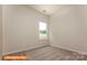 Comfortable bedroom with neutral walls and carpet, showcasing a window view of the outdoors at 1630 Troon Dr, Salisbury, NC 28144