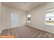 A bright bedroom featuring plush carpeting and natural light from two windows overlooking the construction site at 1630 Troon Dr, Salisbury, NC 28144