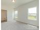 Sunlit bedroom with carpet flooring, two windows, and an ensuite bathroom at 1630 Troon Dr, Salisbury, NC 28144