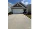Charming single-Gathering home features a two-car garage, tidy landscaping, and a welcoming front porch at 1630 Troon Dr, Salisbury, NC 28144