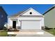 Charming single-Gathering home showcasing a clean white exterior with a prominent two-car garage and a well-manicured lawn at 1630 Troon Dr, Salisbury, NC 28144