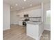 Modern kitchen boasts stainless steel appliances, white cabinetry, and granite countertops at 1630 Troon Dr, Salisbury, NC 28144