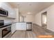 Contemporary kitchen featuring white cabinets, stainless steel appliances, and seamless access to the living space at 1630 Troon Dr, Salisbury, NC 28144